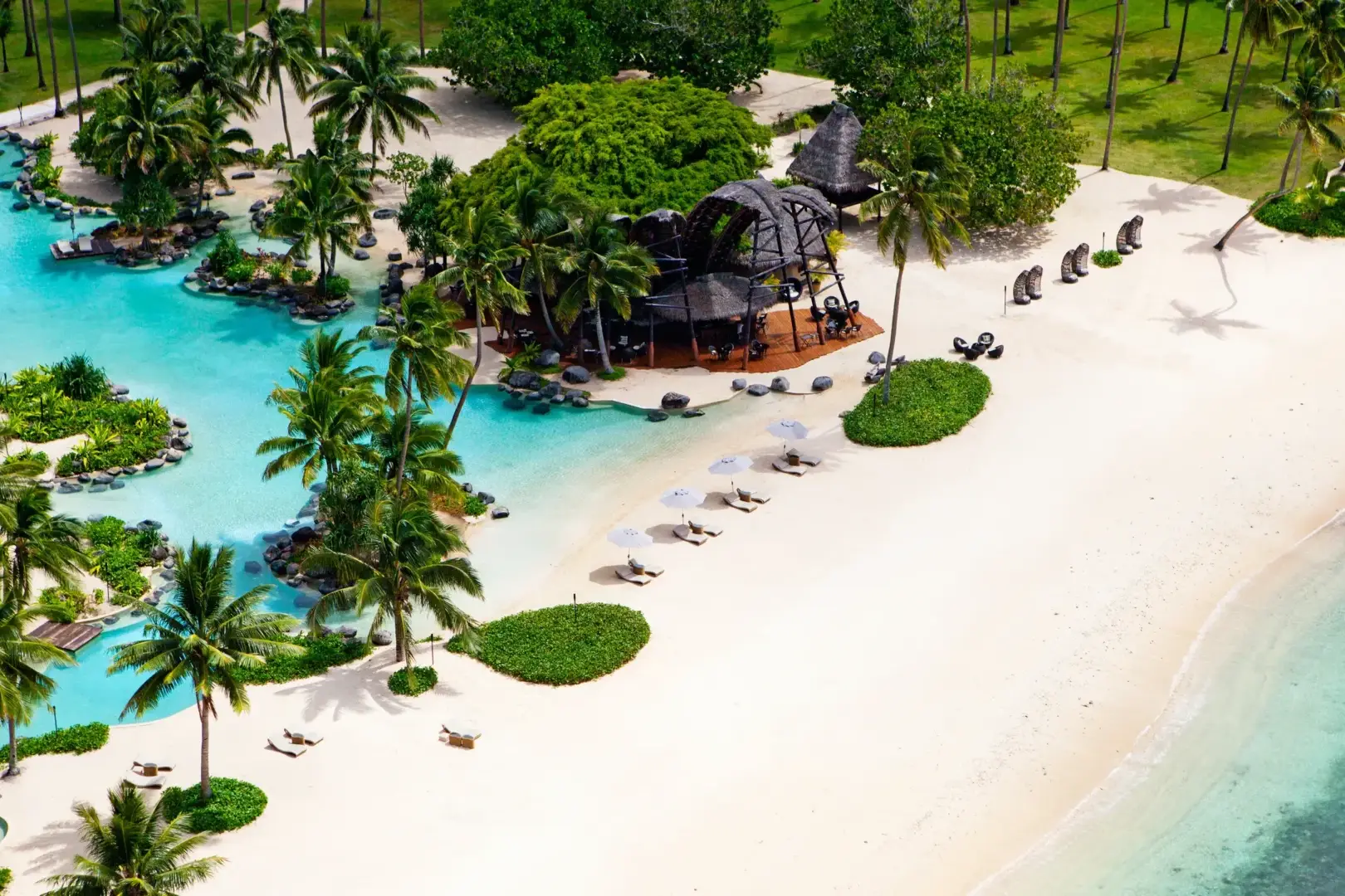 An aerial view of a beach resort with palm trees.