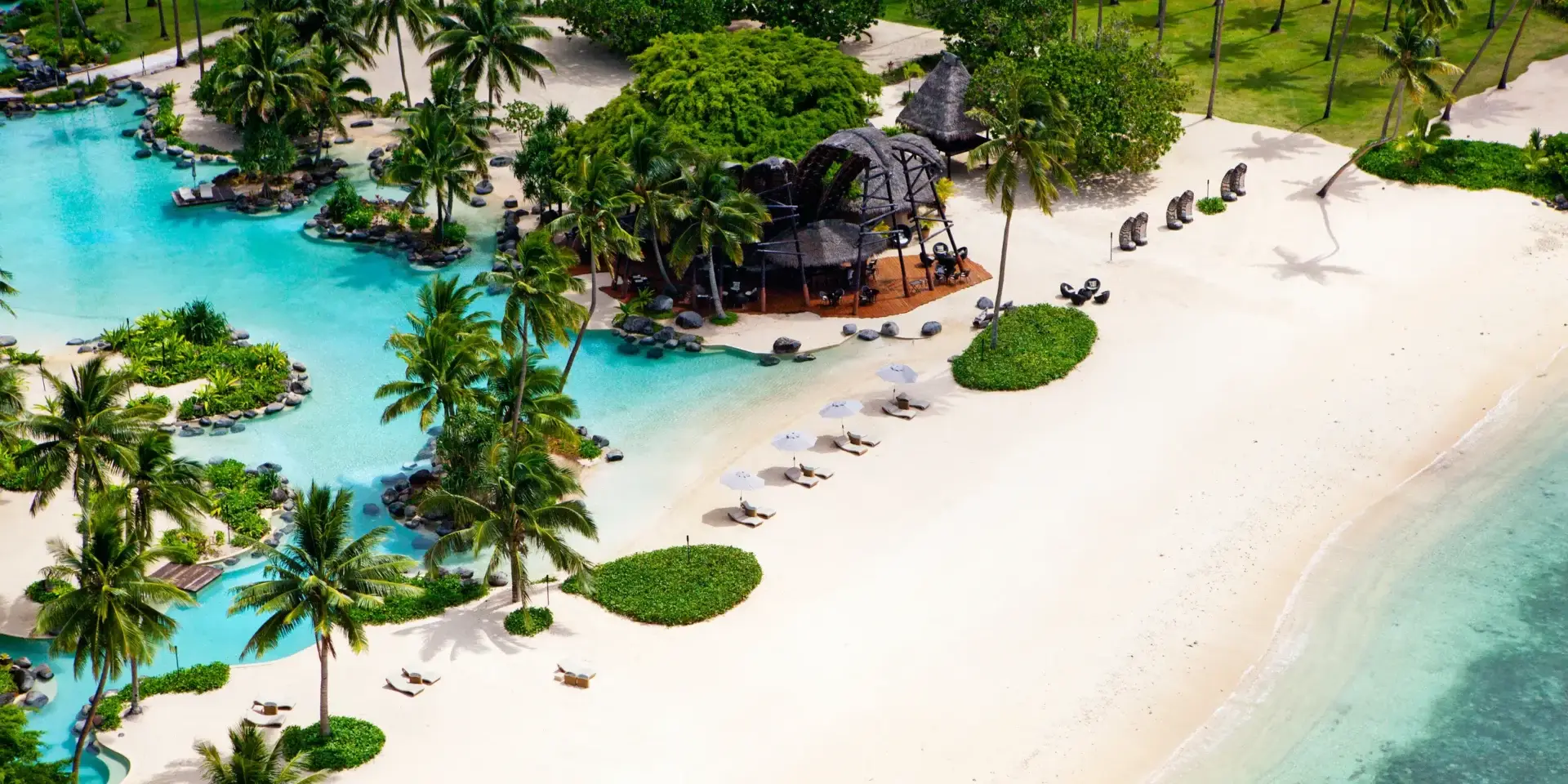 An aerial view of a beach resort with palm trees.