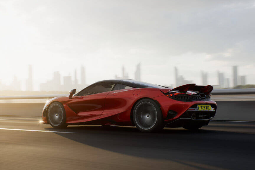 The mclaren 720s is driving down the road.