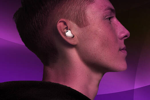 An image of a man wearing earphones in front of a purple background.