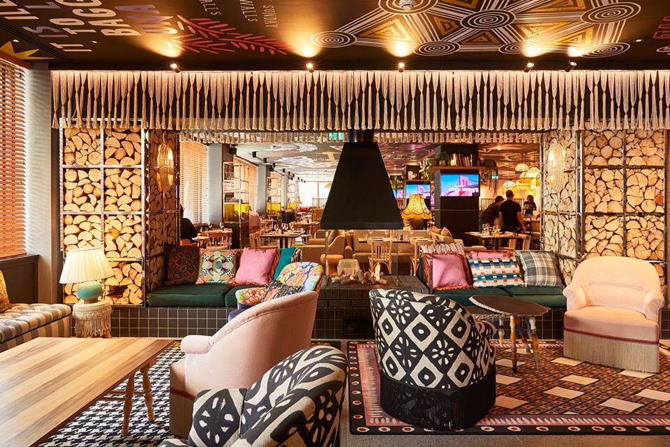 The interior of a restaurant is decorated with a colorful pattern.
