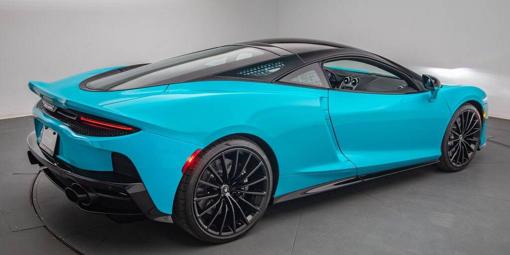 A blue sports car in a room.