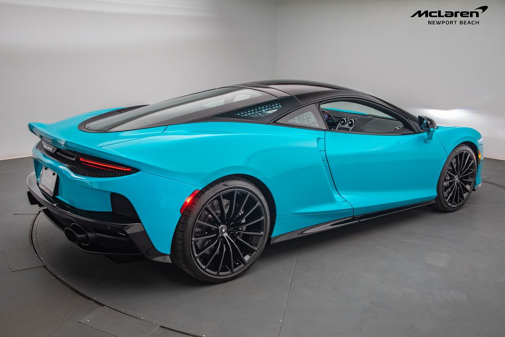 A blue sports car in a room.