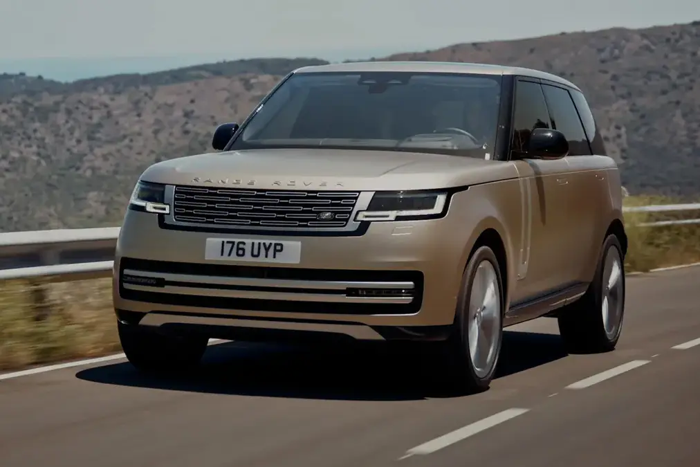 The 2020 land rover vogue is driving down a mountain road.