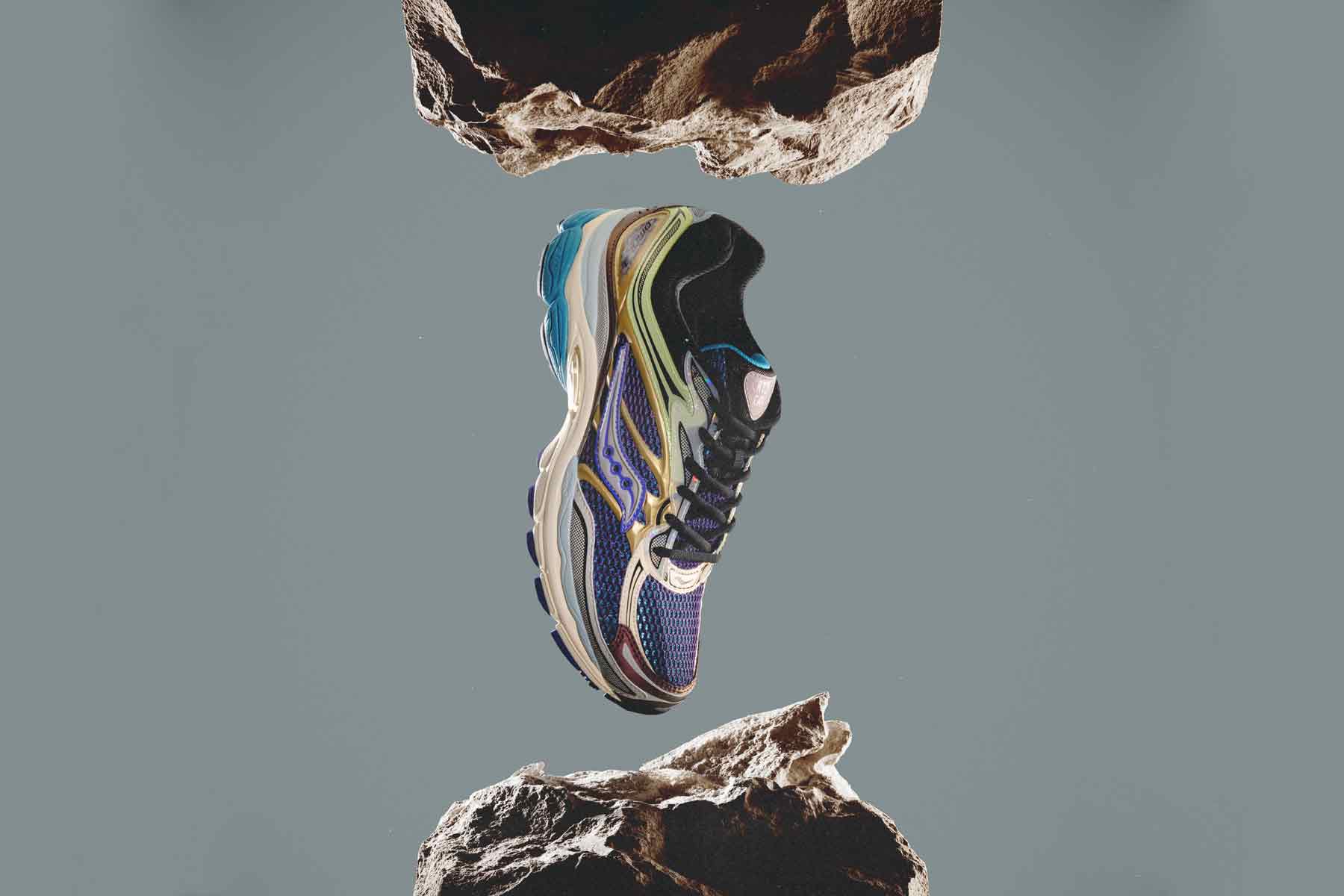 A pair of running shoes hanging from a rock.