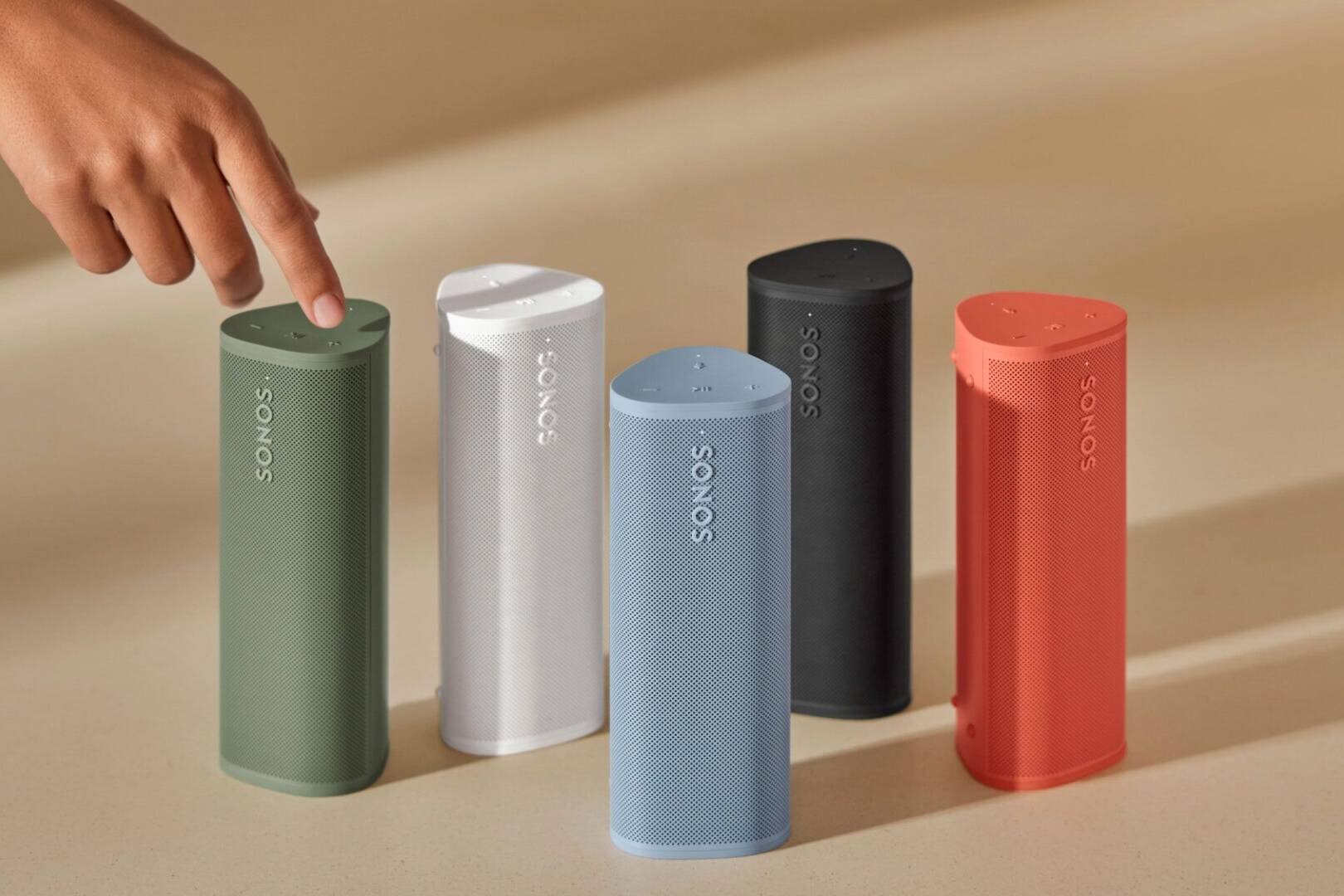 Five Sonos Roam speakers in different colors.